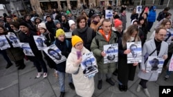 People hold pictures of Russia's political prisoners during a rally in Belgrade, Serbia, Jan. 21, 2023.