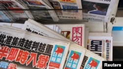 Salinan surat kabar Apple Daily Next Digital terlihat di antara publikasi lain di kios koran di Hong Kong, China, 17 Mei 2021. (Foto: REUTERS/Lam Yik)