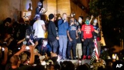 Portland Mayor Ted Wheeler speaks to Black Lives Matter protesters on Wednesday, July 22, 2020, in Portland, Ore.