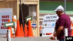 A man walks past the entrance at a near-empty COVID-19 vaccine facility in Los Angeles, California, May 3, 2021. 