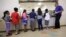 FILE - Detained immigrant children line up in the cafeteria at the Karnes County Residential Center, a detention center for immigrant families, in Karnes City, Texas, Sept. 10, 2014. 