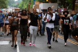 Demonstrators march near the White House, to protest police brutality and racism, on June 10, 2020, in Washington, D.C.