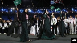 Saudi Arabia's Wojdan Ali Seraj Abdulrahim Shaherkani, center, opening ceremony of the 2012 Summer Olympics, London, July 27, 2012.