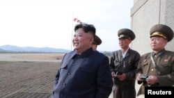 FILE - North Korean leader Kim Jong Un, accompanied by military officials, observes a Korean People's Air Force training flight at undisclosed location in this April 16, 2019, photo released April 17, 2019 by North Korea's Central News Agency (KCNA).