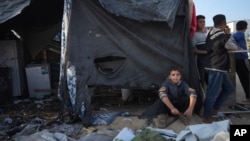 Palestinians gather at the site of an Israeli strike in the courtyard of the Al-Aqsa Hospital, where displaced people live in tents in Deir al-Balah, Gaza Strip, Nov. 9, 2024.