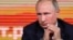 Russian President Vladimir Putin listens to a journalist's question during his annual news conference in Moscow, Dec. 14, 2017.