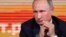 Russian President Vladimir Putin listens to a journalist's question during his annual news conference in Moscow, Dec. 14, 2017.