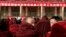About 90 monks sit in front of a red banner that says: "Work Meeting for the Second Phase of Xicang Monastery's Rule of Law Propaganda Education Campaign," ahead of the re-education study session at the 200 year old Xicang Monastery in Luqu, China, Nov. 23, 2008.