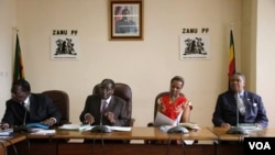 Grace Mugabe sits with the presidium at a Zanu PF meeting.