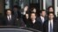 Japan's New Komeito's party leader Natsuo Yamaguchi (C) accompanied by the Japanese ambassador to China Masato Kitera (L) waves his hand as he walks out from the VIP exit of Beijing Capital International airport, January 22, 2013.