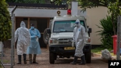 Medical personnel dressed in personal protective equipment are seen outside the main COVID-19 treatment center at Kamuzu Central Hospital in Lilongwe, Malawi, Jan. 18, 2021. 