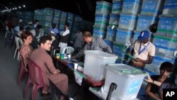 Komisi pemilu Afghanistan memilah kertas suara untuk diaudit di depan para pengamat internasional di kantor komisi pemilu di Kabul, Afghanistan, 27 Agustus 2014.