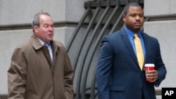 FILE - William Porter, right, one of six Baltimore city police officers charged in connection to the death of Freddie Gray, walks into a courthouse with his attorney Joseph Murtha for jury selection in his trial, Nov. 30, 2015, in Baltimore. 