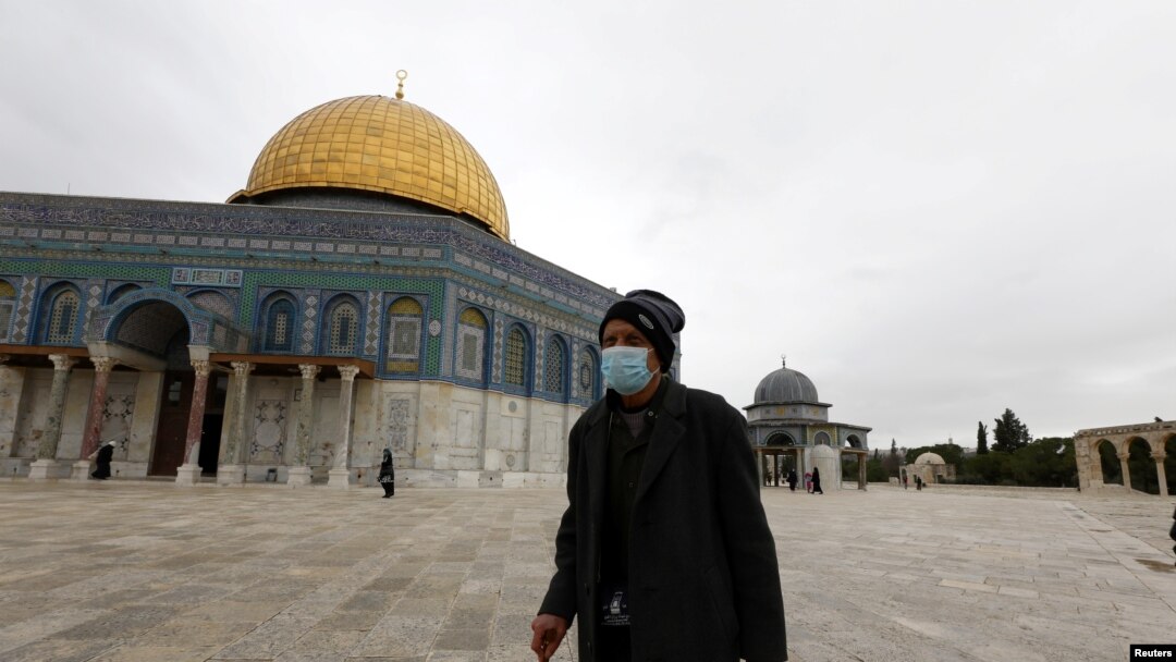 A worshipper walks in front of the Dome of the Rock in the compound known to Muslims as Noble Sanctuary and to Jews as Temple Mount, in Jerusalem's Old City, March 13, 2020.