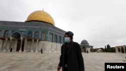 A worshipper walks in front of the Dome of the Rock in the compound known to Muslims as Noble Sanctuary and to Jews as Temple Mount, in Jerusalem's Old City, March 13, 2020.