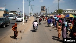 FILE - People walk along a street in Juba, South Sudan, Dec. 21, 2013. Amid a crime wave, residents are paying police unofficially to patrol their neighborhoods.