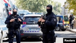 French police forces are seen near the Paris courthouse on the Ile de la Cite ahead of the opening of the trial of the November 2015 Paris attacks in Paris, France, Sept. 7, 2021.