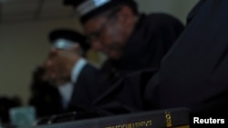 FILE - A copy of the Penal Criminal Code instruction manual sits on a desk during a trial in Port-au-Prince, Haiti.