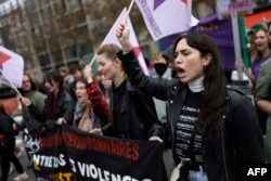 A protester shouts during a rally organized by women's rights groups to defend the right to abortion on International Safe Abortion Day in Paris, Sept. 28, 2024.