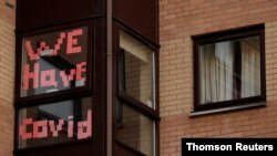 Un letrero en la ventana de un edificio de alojamiento para estudiantes indica: "Tenemos COVID", en Manchester, Gran Bretaña. [Archivo]