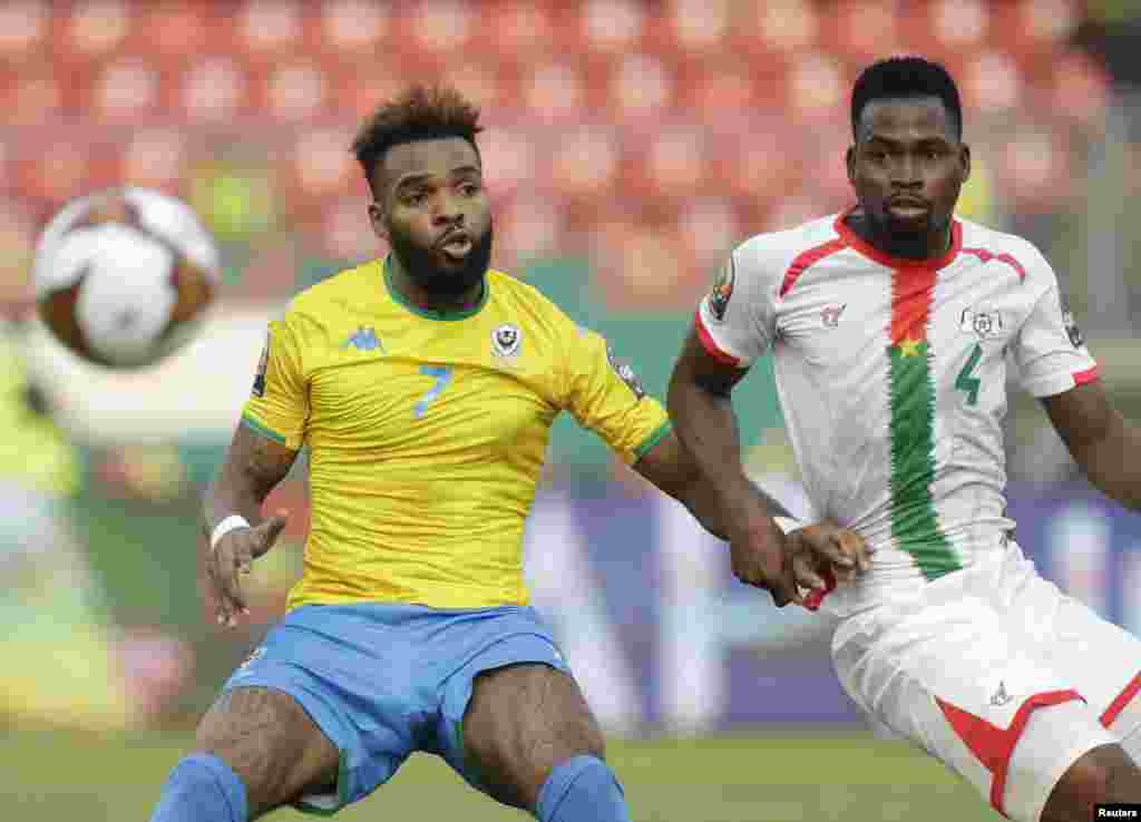 Gabon&#39;s Aaron Boupendza, left, vies for the ball with Burkina Faso&#39;s Soumaila Ouattara, during the match Burkina Faso vs Gabon in Cameroon on Jan. 23, 2022.