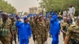 FILE - A handout image posted on the Sudanese Armed Forces's Facebook page on Aug. 31, 2023, shows army chief General Abdel Fattah al-Burhan (C) gesturing as he walks among other army members during a tour of a neighborhood in Port Sudan, in the Red Sea state. (Sudanese Army/AFP)