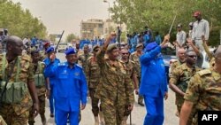 FILE - A handout image posted on the Sudanese Armed Forces's Facebook page on Aug. 31, 2023, shows army chief General Abdel Fattah al-Burhan (C) gesturing as he walks among other army members during a tour of a neighborhood in Port Sudan, in the Red Sea state. (Sudanese Army/AFP)