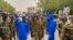 FILE - A handout image posted on the Sudanese Armed Forces's Facebook page on Aug. 31, 2023, shows army chief General Abdel Fattah al-Burhan (C) gesturing as he walks among other army members during a tour of a neighborhood in Port Sudan, in the Red Sea state. (Sudanese Army/AFP)