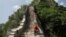 A man rests while working on the reconstruction of the Jiankou section of the Great Wall, located in Huairou District, north of Beijing, China, June 7, 2017. 