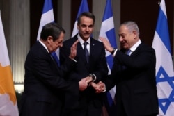 Cypriot President Nicos Anastasiades, Greek Prime Minister Kyriakos Mitsotakis and Israeli Prime Minister Benjamin Netanyahu pose for a photo before signing a deal to build a gas pipeline, in Athens, Greece, Jan. 2, 2020.