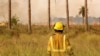 A firefighter works on a bushfire near San Luis del Palmar, Corrientes province, Argentina on February 12, 2025.