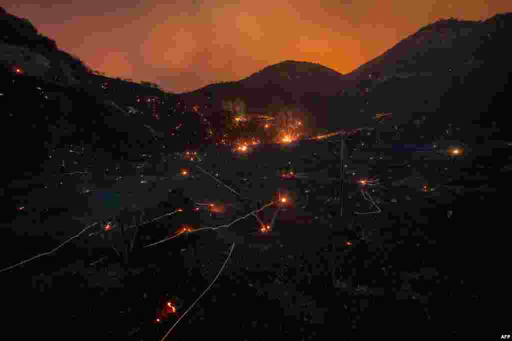 A time exposure shows embers from Saddleridge Fire blown by the wind in the Porter Ranch section of Los Angeles, California.