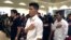FILE - Long Chi Vong, 16 (C), from Albuquerque, and other immigrants stand for the U.S. Pledge of Allegiance before taking the Oath of Citizenship at a ceremony in Rio Rancho, N.M., Aug. 19, 2016
