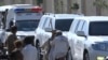 People watch a convoy carrying Bushra Bibi, wife of Pakistan's imprisoned former Prime Minister Imran Khan, leave following her release from prison a day after a court granted her bail in a graft case, in Rawalpindi, Pakistan, Oct. 24, 2024.