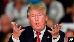 Republican presidential candidate Donald Trump gestures as he speaks during a rally at West High School in Sioux City, Iowa, Oct. 27, 2015. 