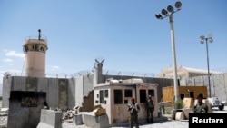 Afghan soldiers stand guard at the gate of Bagram Airfield, on the day the last of the American troops vacated it, Parwan province, Afghanistan, July 2, 2021.