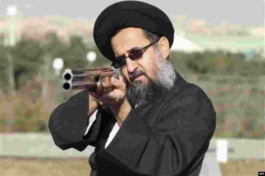In this Friday, Jan. 6, 2012 photo taken by semi-official Mehr News Agency, an unidentified Iranian clergyman aims during a shooting exercise organized by Iran's Shooting Federation at the Azadi (Freedom) sport complex in Tehran, Iran. (AP Photo/Mehr News