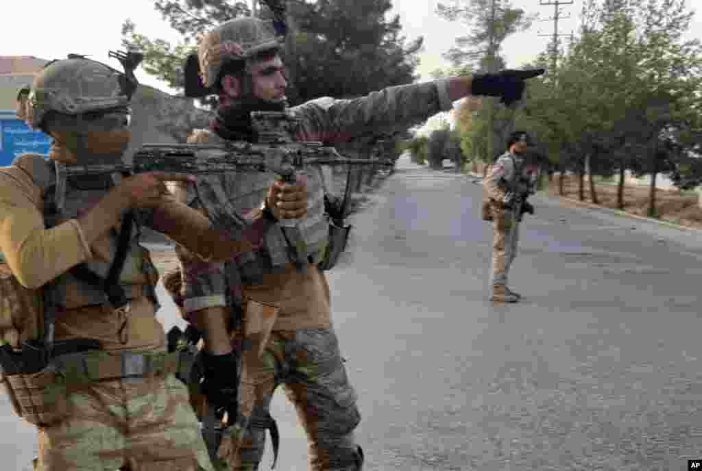 Afghan Special forces patrol a deserted street during fighting with Taliban fighters, in Lashkar Gah, Helmand province, southern Afghanistan.
