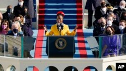 FILE - National youth poet laureate Amanda Gorman recites her inaugural poem during the 59th Presidential Inauguration at the U.S. Capitol in Washington, Jan. 20, 2021.