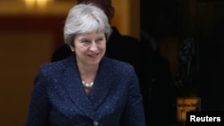 Britain's Prime Minister Theresa May emerges from 10 Downing Street in Westminster, London, Britain, July 9, 2018. 