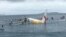 People are evacuated from an Air Niugini plane crashed in the waters in Weno, Chuuk, Micronesia, in this picture obtained from social media. 