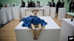 A toy doll is displayed as visitors look at items presented at the Museum of Broken Relationships in Pristina, Kosovo, May 3, 2018.