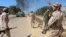 Soldiers from a force aligned with Libya's new unity government walk along a road during an advance on the eastern and southern outskirts of the Islamic State stronghold of Sirte, in this still image taken from video on June 9, 2016.