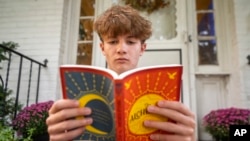 Chris Stanislawski, 14, outside of his home in Garden City, NY, on Sept. 13, 2024. He didn't finish any books in his 8th grade English class, in part because his classroom had detailed summaries of each chapter of every book.