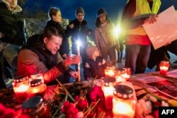 FILE — People light candles to pay their tribute to late Russian opposition leader Alexei Navalny, who died in a Russian Arctic prison, during a candle vigil in downtown Zagreb on February 23, 2024.