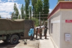 Indian army soldiers carry the body of their colleague, who was killed in a border clash with Chinese troops, to an autopsy center at the Sonam Norboo Memorial Hospital in Leh, June 17, 2020.