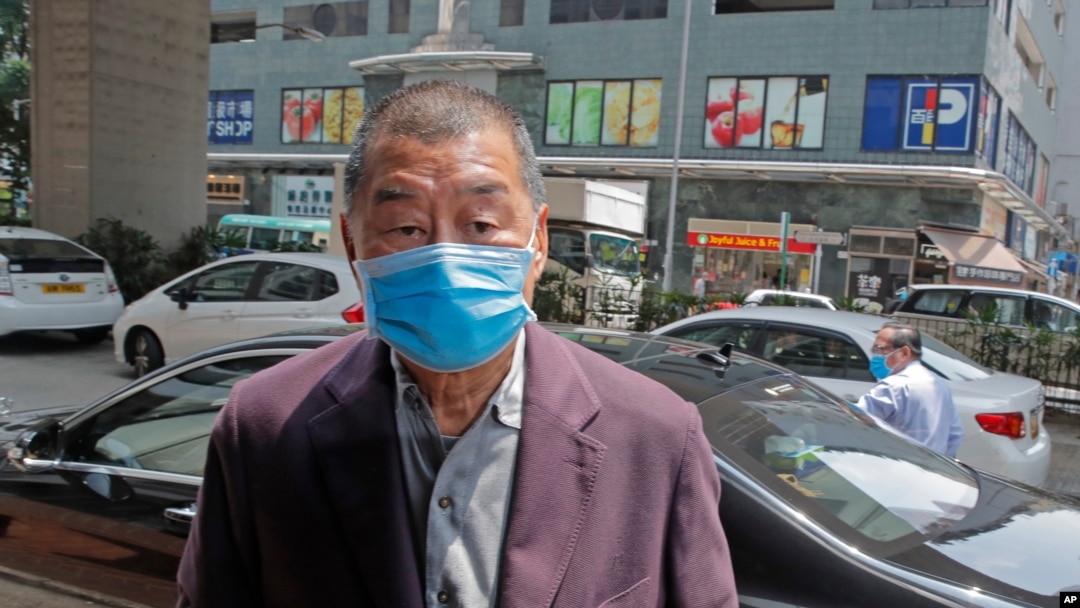 FILE - Pro-democracy media tycoon Jimmy Lai arrives at a police station in Hong Kong.