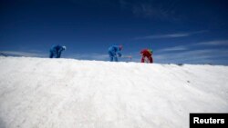 FILE - Laborers work at the Rockwood lithium plant on the Atacama salt flat, the largest lithium deposit currently in production, in the Atacama desert of northern Chile, Jan. 8, 2013.