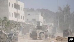 An Israeli army bulldozer operates at the parameter of the Nur Shams refugee camp during the ongoing army operation, in the West Bank city of Tulkarem, Oct. 31, 2024.