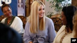 White House senior adviser Ivanka Trump, center, smiles at Azalech Tesfaye, right, who is the recipient of loan guarantee through USAID, as Trump meets women who work in the Ethiopian coffee industry, Sunday April 14, 2019, at Dumerso Coffee in Addis Ababa, Ethiopia. 